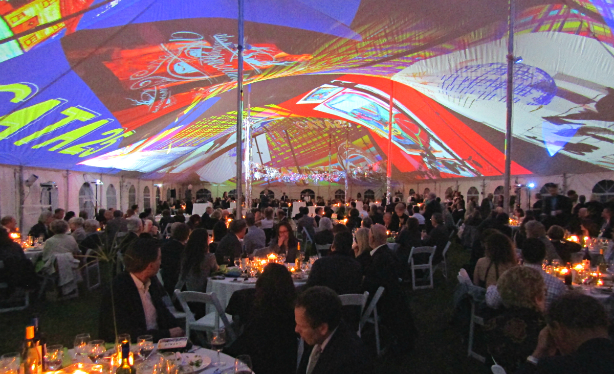 Candlelight and colorful projections from Joe Wheaton set the scene for dinner and dancing.