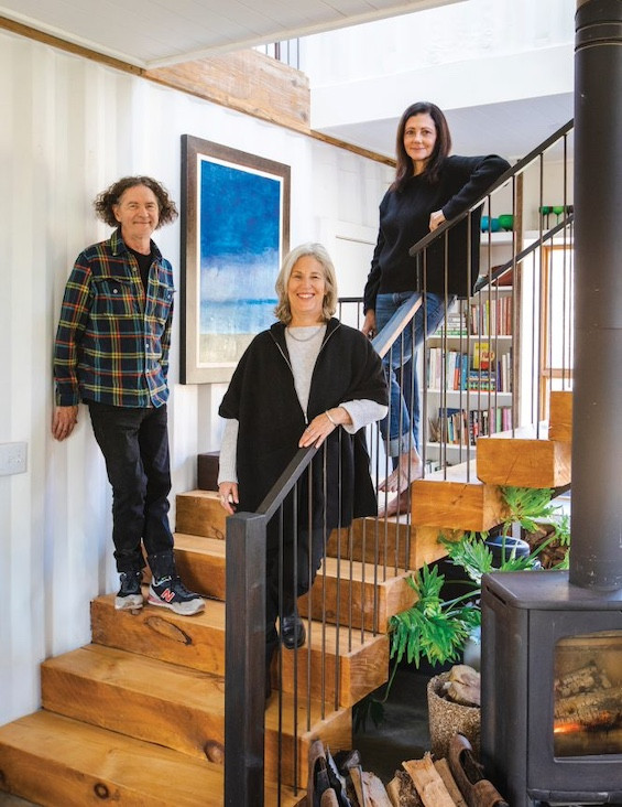 Cornillon poses on the staircase he designed alongside current homeowner Lori Greenberg, center, and designer Elyse Kroll.