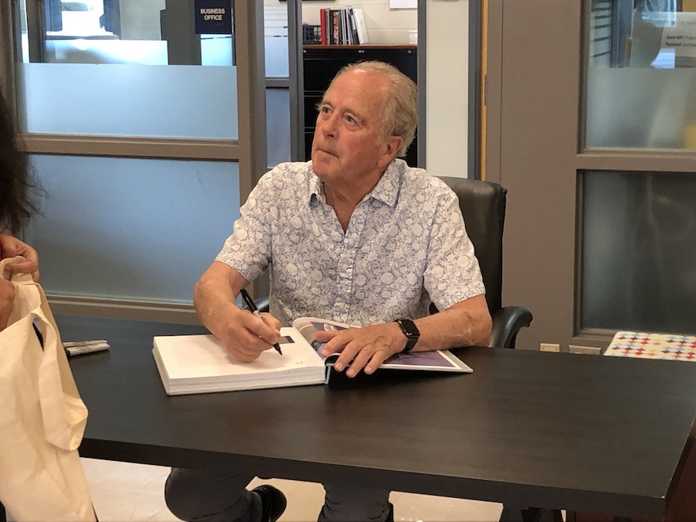 Sculptor Don Gummer signs his book.