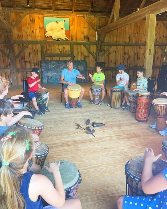 At Flying Cloud&#39;s S-M-Art summer&nbsp;camp at April Hill in Egremont. The youth are drumming&nbsp;with musician Rick Strum on his collection of African drums. Photo credit: Maria Rundle