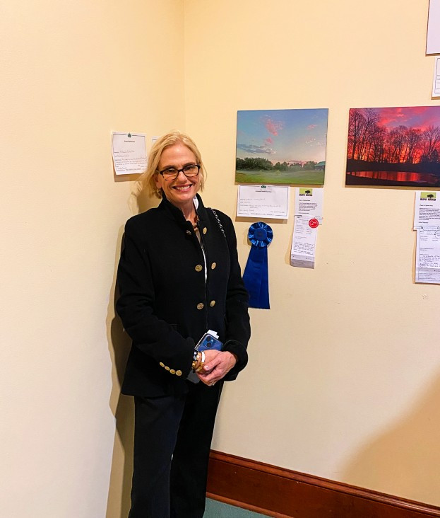 Emma Sweeney Lewis, president of the Millbrook Garden Club, in front her photo, which won the Garden Club of America Novice Award. Photo: Tom Kopfensteiner Emma Sweeney Lewis, president of the Millbrook Garden Club, in front her photo, which won the Garden Club of America Novice Award. Photo: Tom Kopfensteiner