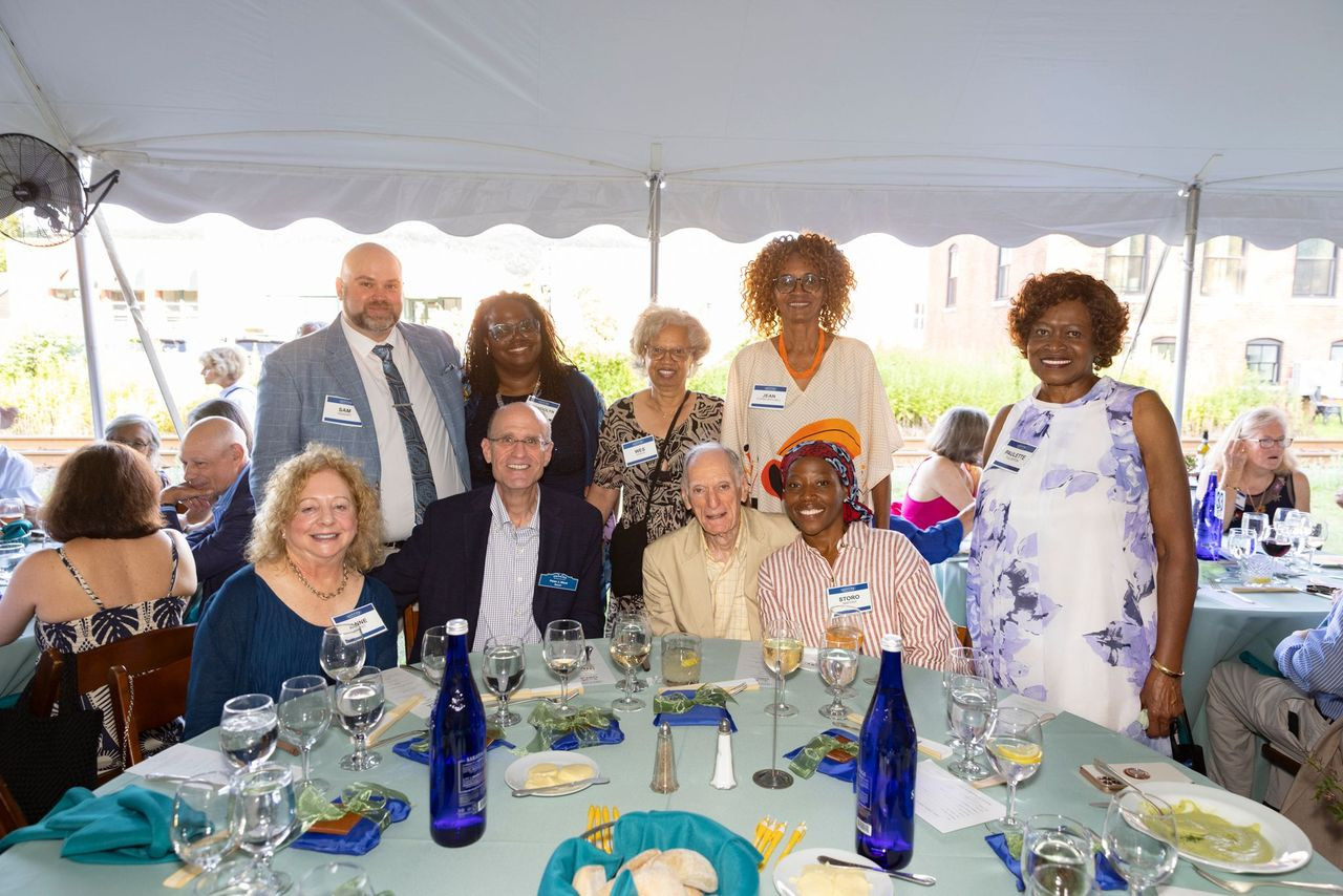 Back row: Sam and Gwendolyn VanSant, Wes Gadson, Jean Clarke-Mitchell, Paulette Fullerton. Front row: Anne Most, Board Member Peter Most, Edmund A. Grossman, and Storo Maposa.