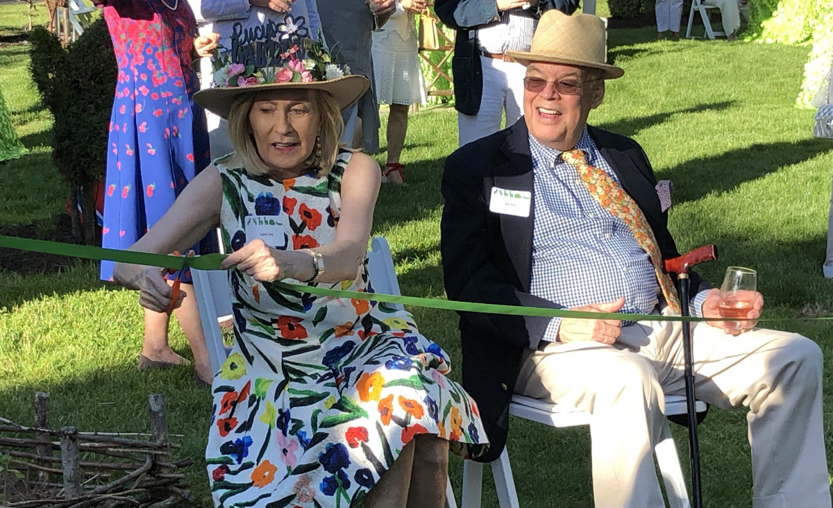 Lucy Day cuts the ribbon as Nat Day looks on. Lucy Day cuts the ribbon as Nat Day looks on.