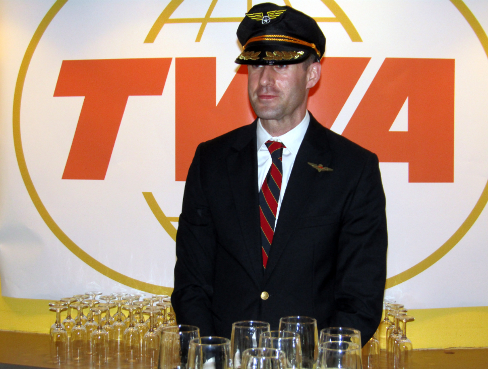 A dapper bartender assisting with drinks A dapper bartender assisting with drinks