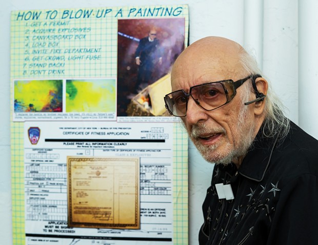 Tery Fugate-Wilcox in front of Fulcrum Gallery (480 Broome Street, Manhattan) on March 17, 1995, before an Actual Art event in which firecrackers were placed in a container and set off to splatter paint onto a canvas, part of a series of work by the artist that employed small explosions.