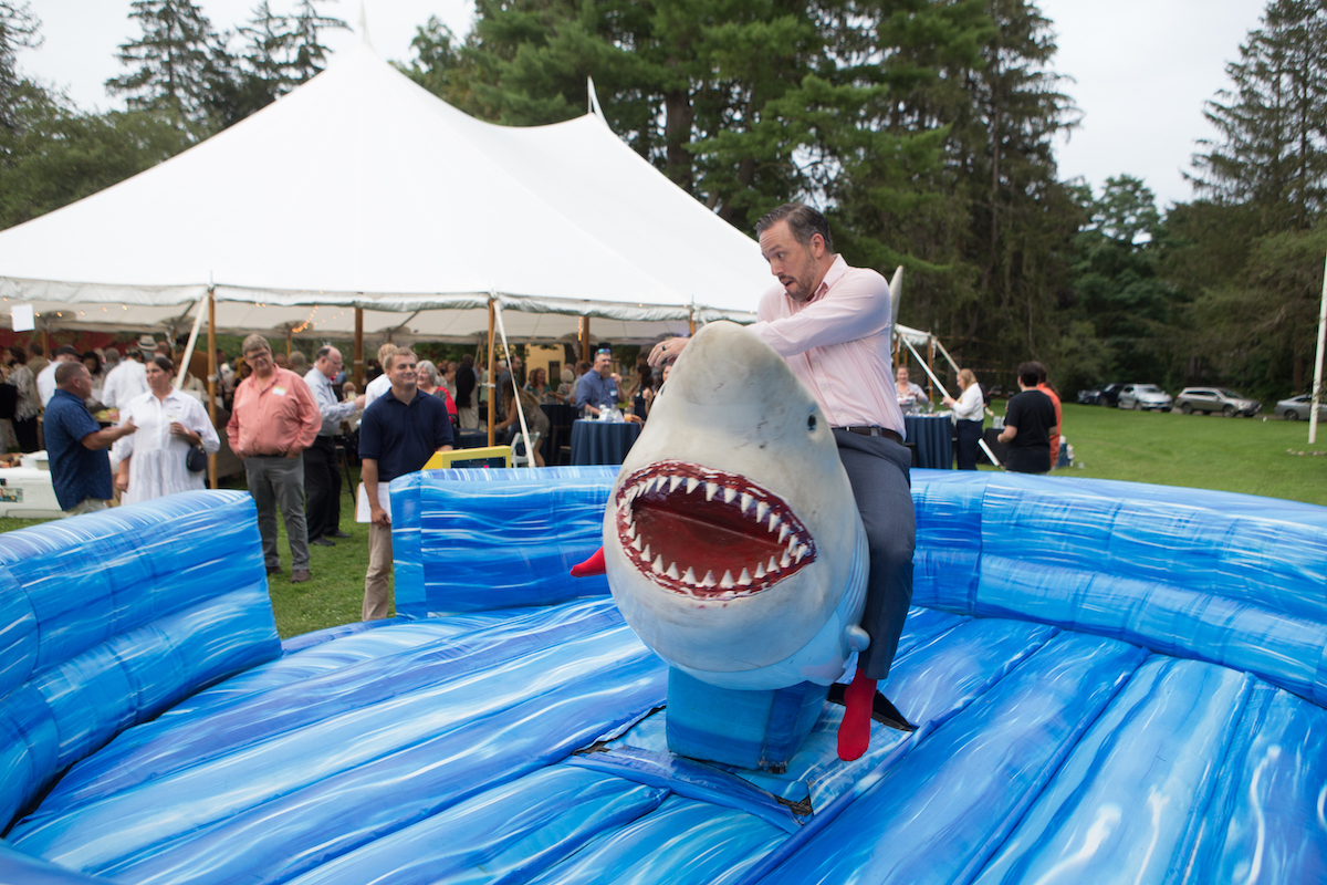 Berkshire Museum Trustee Evan Hickok rides the mechanical shark