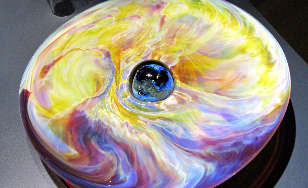 A glass disk from the exhibit Josh Simpson: Galactic Landscapes.