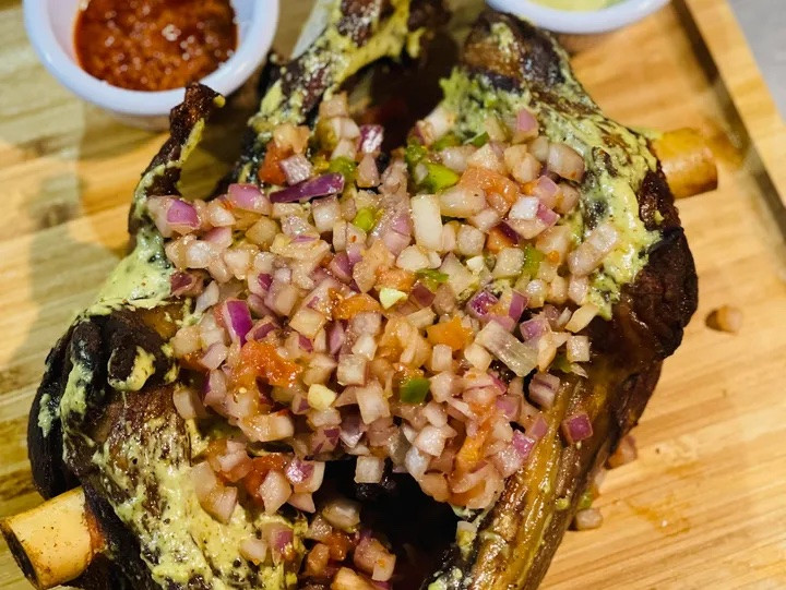 Gigot — Barbecue-roasted lamb legs in special green sauce with onions. Gigot — Barbecue-roasted lamb legs in special green sauce with onions.