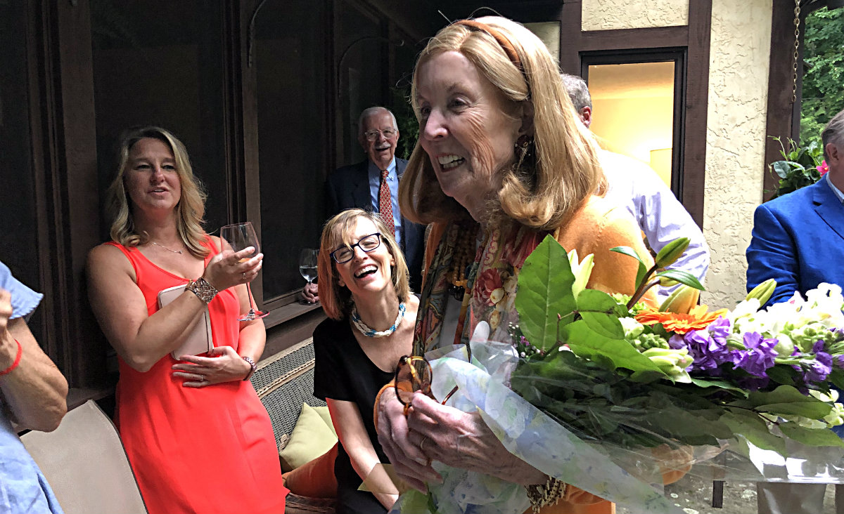 Jane Havermeyer receives flowers in appreciation for her funding of the Jane L. Havermeyer Fund for Client Financial Assistance.