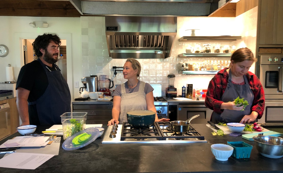 Guests Max Rivinus and Aretha Whitehead with Tracy Hayhurst (center) in the kitchen