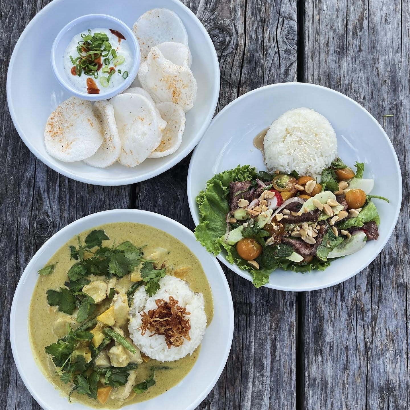 Sour cream and&nbsp;onion dip with old bay prawn chips, shaved beef salad with sticky rice, yellow fish curry with crispy shallots