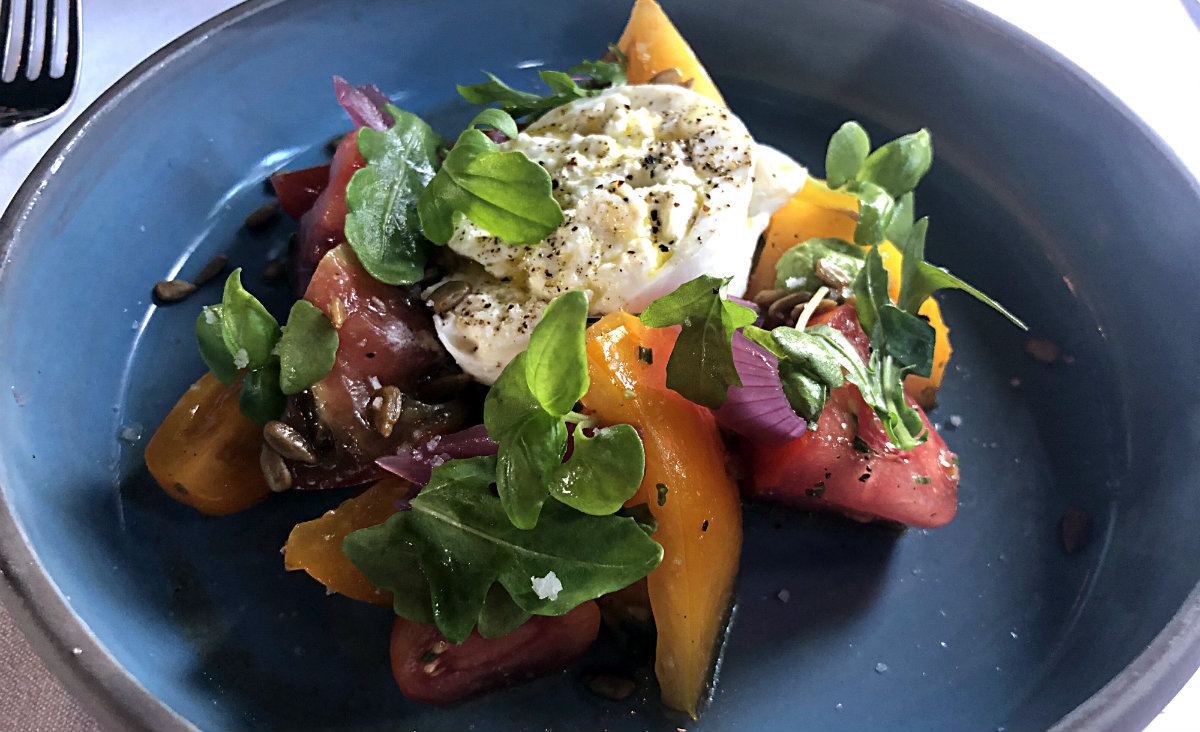 Heirloom tomato salad, burrata, red onion, arugula, basil-sunflower pesto Heirloom tomato salad, burrata, red onion, arugula, basil-sunflower pesto
