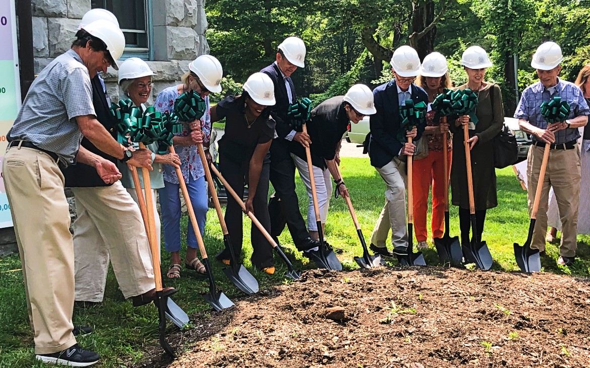 Board and bulding committee members break ground.