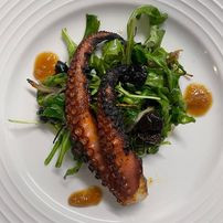 Charred Spanish octopus, oil-cured olives, lemon confit, arugula, shallots