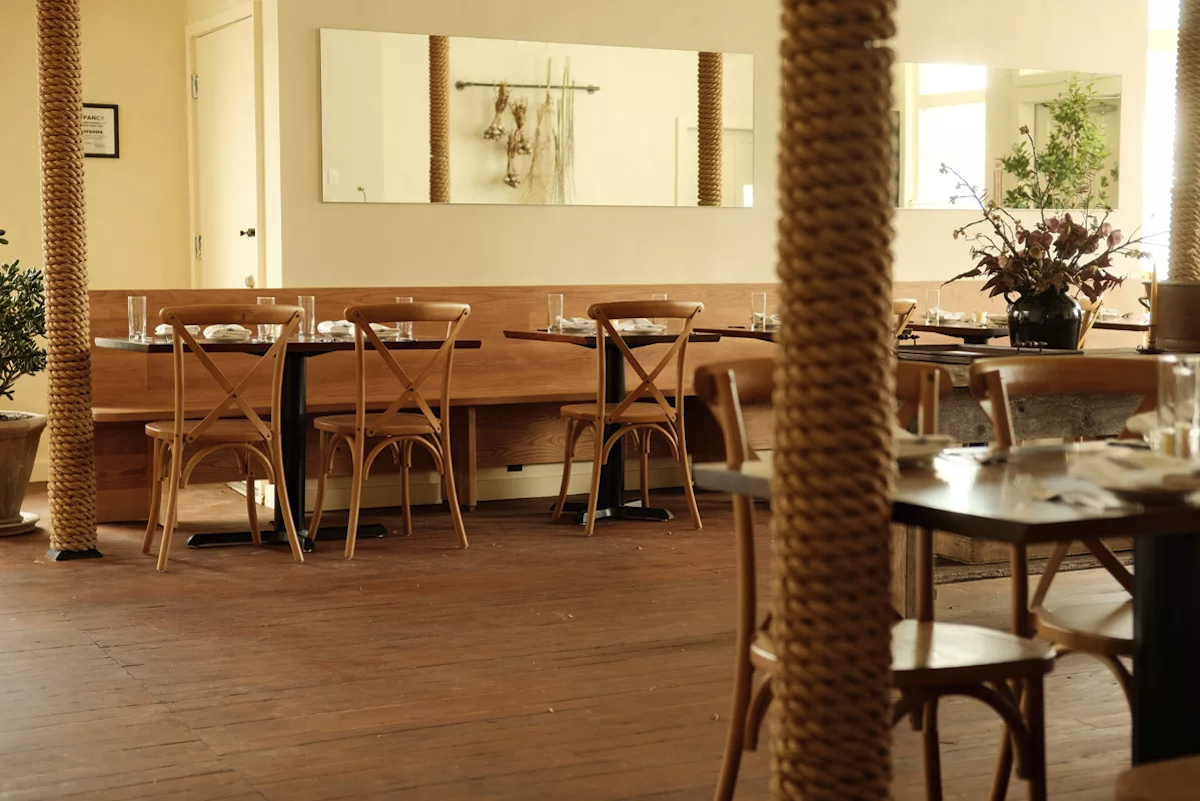 With just 44 seats, the dining room offers space to breathe. Blonde wood tables and syrup-colored floors keep things warm within the minimalist, farmhouse-chic setting. - Isabela With just 44 seats, the dining room offers space to breathe. Blonde wood tables and syrup-colored floors keep things warm within the minimalist, farmhouse-chic setting. - Isabela