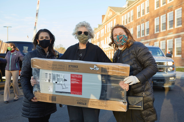 Hudson City School District Superintendent Dr. Maria Suttmeier, New York State Assembly Member Didi Barrett, and Chris Jones hand out desks.
