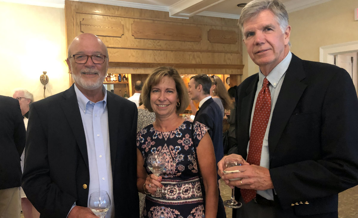 Board members Don Pfeifer and John Dickson flank Suzanne Pfeifer