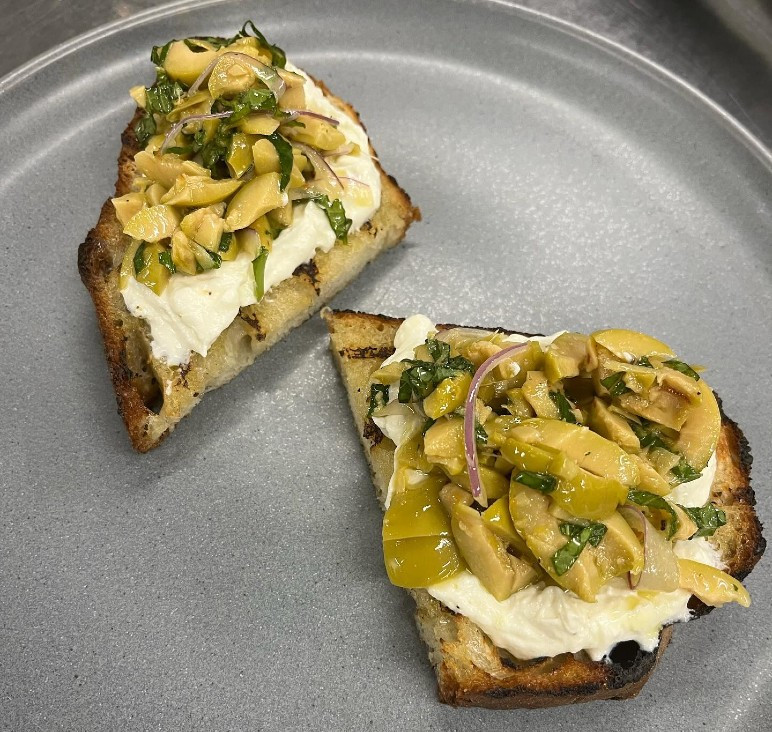 Green olive and ricotta crostini, from the Cichetti menu