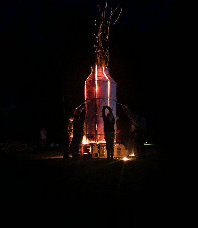 Volunteers stand ready to pull the kiln petals down.