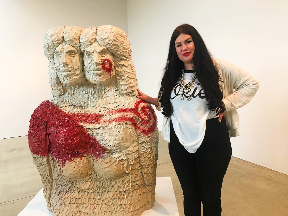 Raven Halfmoon, the artist, stands beside her work&nbsp;Bah&#39;hatteno Ina (Red River Mother), 2022