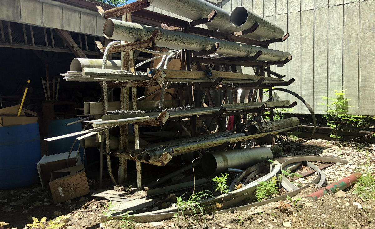 Raw materials are stacked up at the back of Butler&#39;s workshop. - Lisa Green