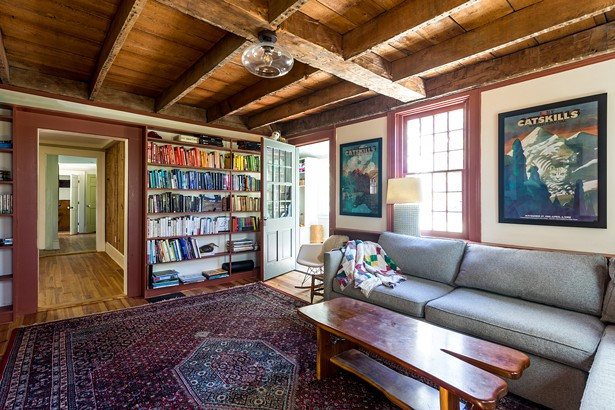 When the Reisfelds purchased the home, the first floor’s original dining room had been damaged by a flood. However, it turned out to be a blessing in disguise, uncovering the home’s original wood ceiling beams. “We knew we couldn’t cover them back up,” says Reisfeld. “They are all hand- cut and you can see the original Roman numerals on some.” The family now uses the space as a den. A collection of vintage Milton Glaser prints hangs along the wall. When the Reisfelds purchased the home, the first floor’s original dining room had been damaged by a flood. However, it turned out to be a blessing in disguise, uncovering the home’s original wood ceiling beams. “We knew we couldn’t cover them back up,” says Reisfeld. “They are all hand- cut and you can see the original Roman numerals on some.” The family now uses the space as a den. A collection of vintage Milton Glaser prints hangs along the wall.