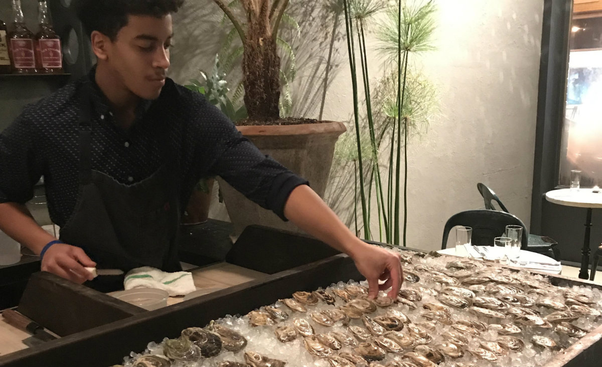 Xavier Conway shucks oysters at Botanica. Photo: Mary Nelen