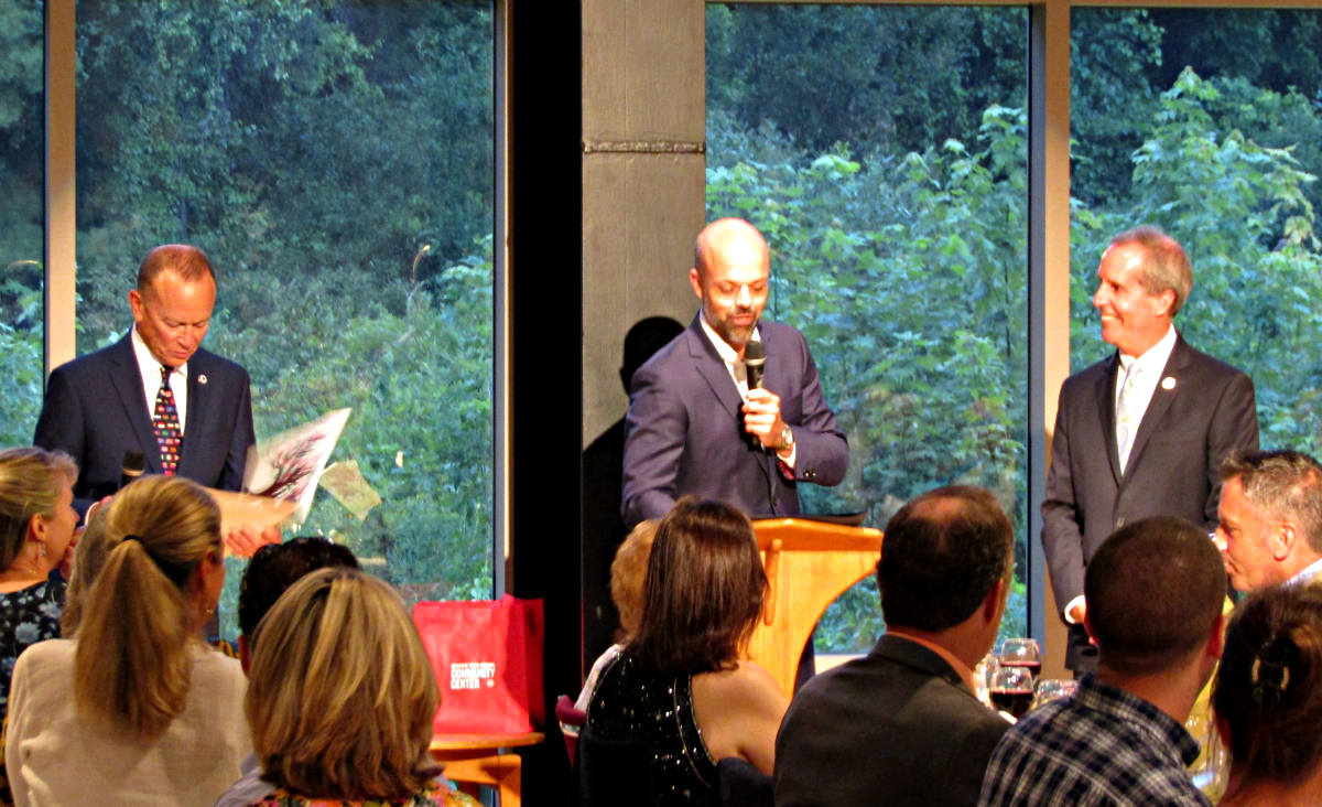 Robin McGraw reads over a citation for Smitty from the children of Berkshire South, while State Senator Adam Hinds reads aloud a citation from the MA state legislature.
