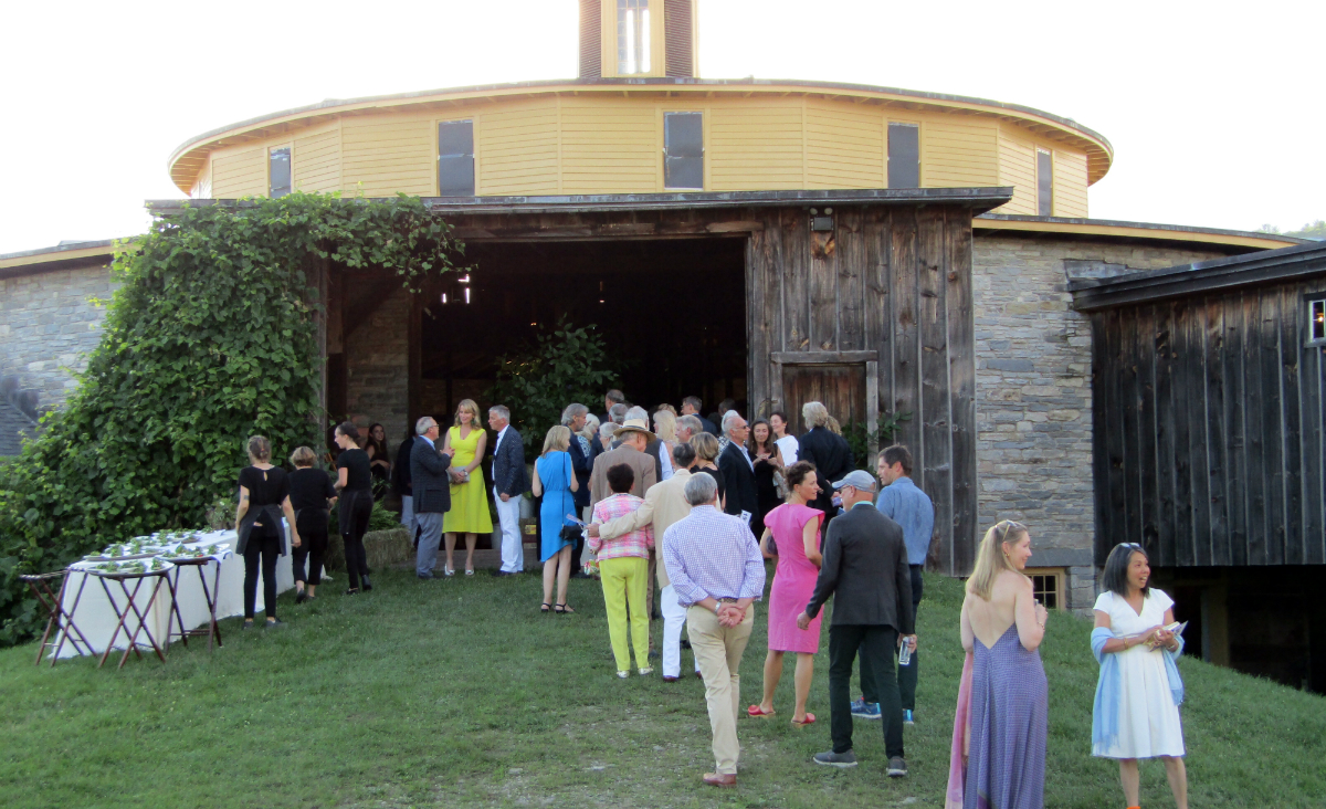 Guests enter The Round Stone Barn for dinner. Guests enter The Round Stone Barn for dinner.