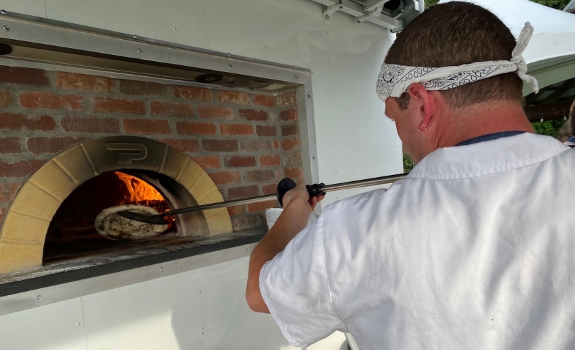 <p>Pizza maker <a href="https://ruralintelligence.com/food/pizza-on-and-of-the-farm-pops-up-at-katchkie-in-kinderhook" target="_blank">Rafi Bildner&nbsp;</a>makes pies out of his pizza wagon.</p>